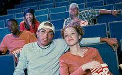 teenage girl and 
a young man watching 
a movie in a movie 
theater. fotosearch 
- search stock 
photos, pictures, 
images, and photo 
clipart